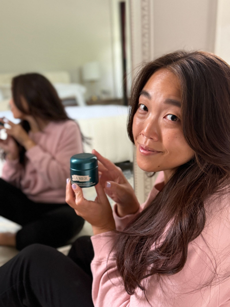 Allure contributing commerce writer Christa Joanna Lee holding the La Mer The Rejuvenating Night Cream